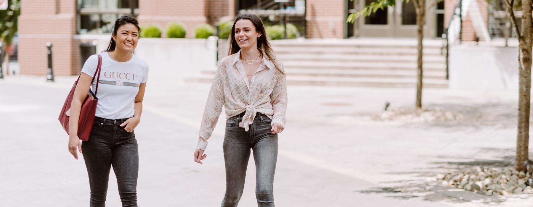 a couple of women walking on a street