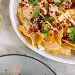 a plate of nachos and a lemon