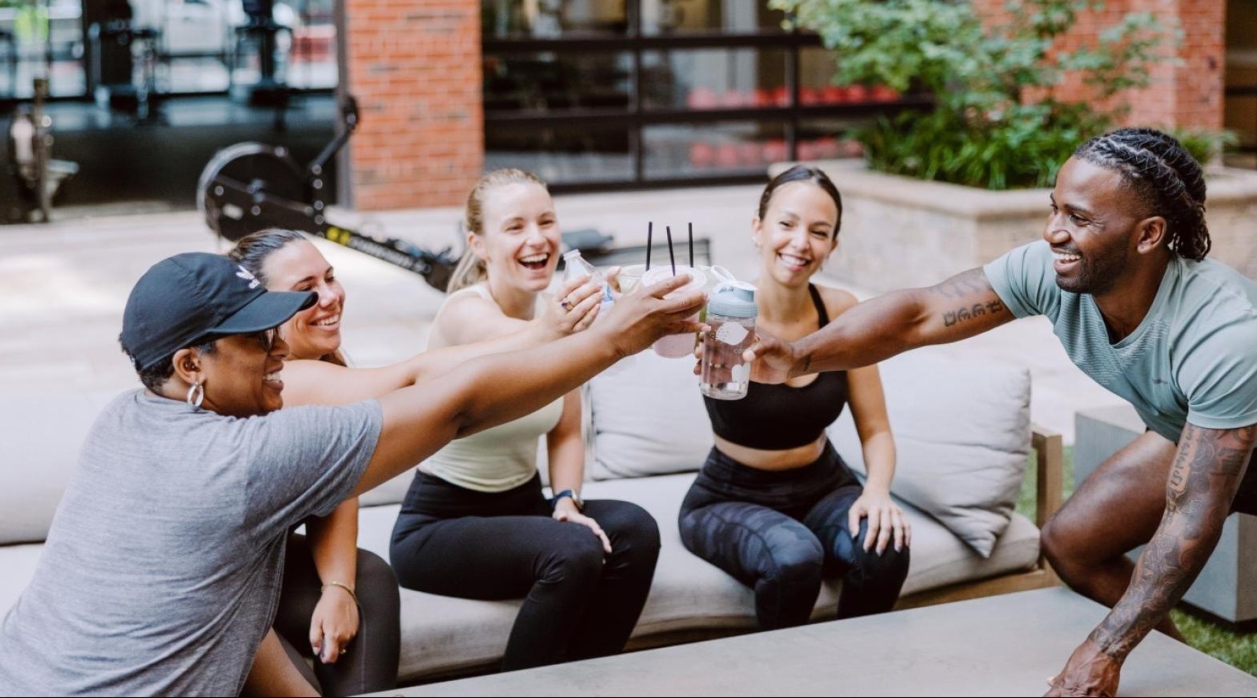 a group of people sitting on a bench and laughing